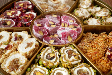 Eastern sweets with nuts, candy, dates in box background