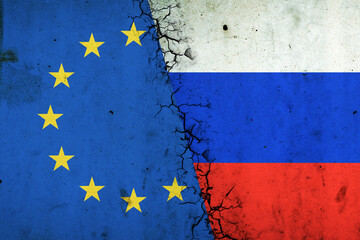Cracked Euro Union and Russia flags. Rupture of economic relations. Sanctions. Economic crisis. War between Russia and Ukraine.