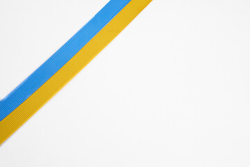 Ukraine flag with blue and yellow ribbons isolated on a white background. The concept of supporting...