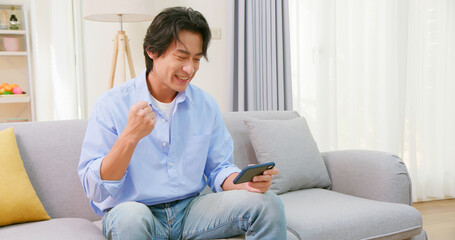 Fototapeta premium asian man play mobile games