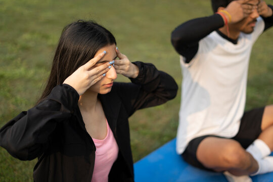 An Indian Young Couple Doing Yoga Early In The Morning, Boy And Girl Doing Yoga In The Park.Healthy Lifestyle Concept.