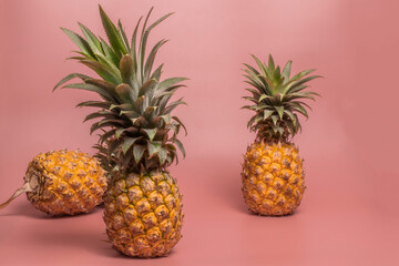 Minimal healthy food fruit pineapple on pink table.