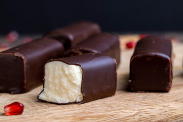dessert of creamy filling and chocolate on a board