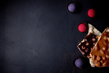 Chocolates background. Chocolate. Assortment of fine chocolates in white, dark, and milk chocolate....