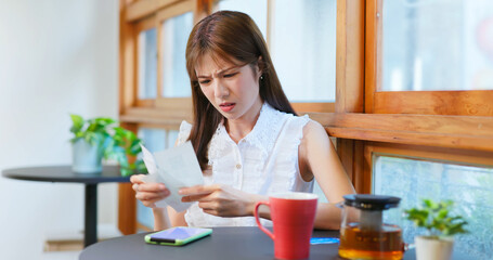 woman look at shopping bills