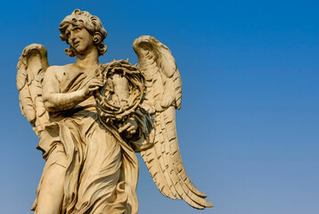 Rome, Italy - June 2000: A stone statue of an angel on a blue sky background