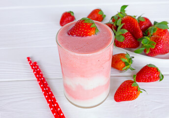 Strawberry yogurt fruit juice smoothie pink colorful fruit juice milkshake blend beverage healthy high protein the taste yummy In glass drink episode morning on white wood background.