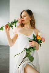 Beautiful woman in white dress with flowers