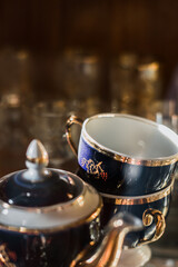 Antique old service. Old service in a sideboard at a summer cottage. collection of tea porcelain service, cobalt gilding, service behind the flow