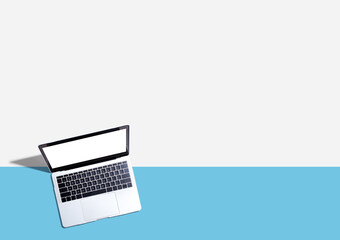 Laptop computer with shadow from above - Flat lay