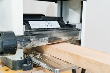working with wood on the planing machine