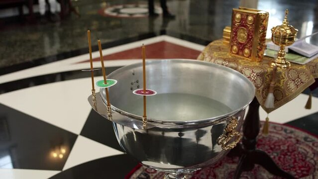 baptismal bowl in church with holiday candles