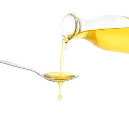Pouring cooking oil from glass bottle into spoon isolated on white background.