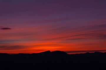 Obraz premium An amazing Sunrise over the mountains. Panoramic view of gorgeous pink sunrise.