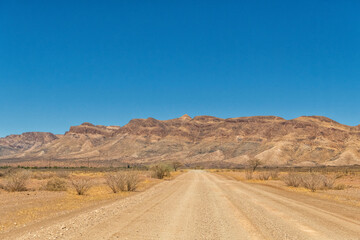 Fototapeta na wymiar off through the desert to the mountains of Namib-Naukluft, Namibia