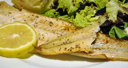 Grilled fish on salad mattress