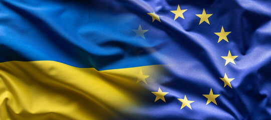 Ukrainian and the EU flag blending into each other as European Union leans towards the membership of Ukraine - obrazy, fototapety, plakaty