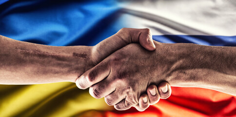 A handshake above the Ukrainian and Russian flags