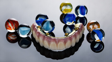 an interesting angle on the dental prosthesis made of zircon and titanium with glass colored balls