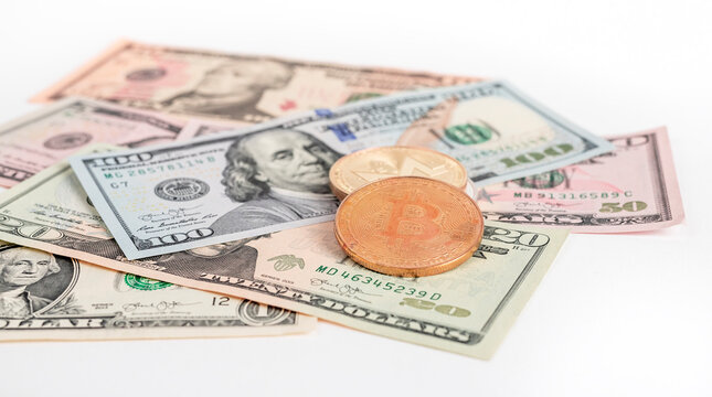 Bitcoin coins at dollar bills pile. Cryptocurrency and cash money concept. High quality photo