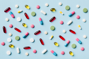 Many different pills and space for text on colorful background, top view. Different pills on color background, flat lay