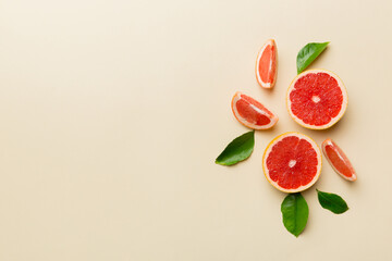 fresh Fruit grapefruit with Juicy grapefruit slices on colored background. Top view. Copy Space. creative summer concept. Half of citrus in minimal flat lay with copy space - obrazy, fototapety, plakaty