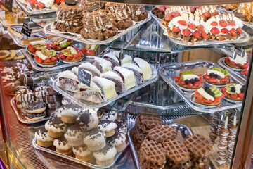 Appetizing Dutch pastries on display in a counter of a bakery.