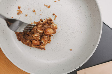 Close up of pieces of soft cookie being eaten with fork.