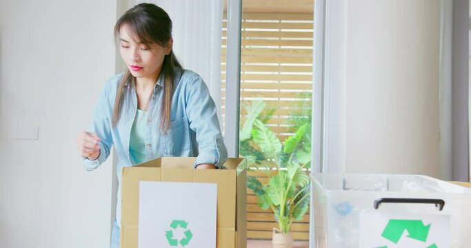 woman is recycling at home