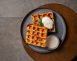 Belgian cheese waffles with poached egg and sauce