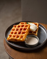 Belgian cheese waffles with poached egg and sauce