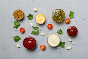 Many different sauces and herbs on table, flat lay top view. sauces with spices healthy concept