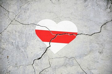 The symbol of the national flag of Belarus in the form of a heart on a cracked concrete wall.