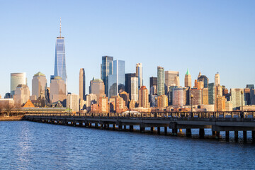 Jersey City, New Jersey, USA - December 22 2021: New York City downtown skyline. Financial district and World Trade Center. View from Statue of Liberty State Park.
