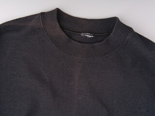An old black battered hoodie without a hood. Top view