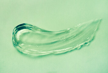 Cream gel green transparent cosmetic sample texture with bubbles isolated on white background