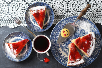 Valentines day, red strawberry pie on blue plates and a gift in a red box 