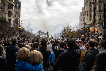 Multitude of People Attentively Observing the Explosion of Firecrackers of the Mascleta de Valencia in Fallas from the Town Hall Square - obrazy, fototapety, plakaty