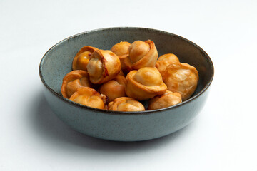 Fried dumplings in a plate on a white background.