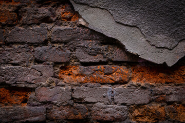 Old, black brick wall torn