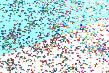 Abstract pattern of random falling stars with moon and heart on a blue and white background.