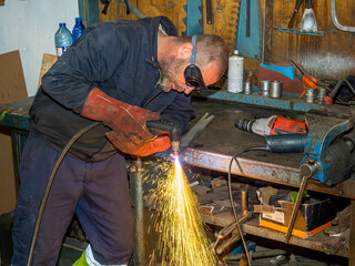 Professional welder using a plasma cutting machine.