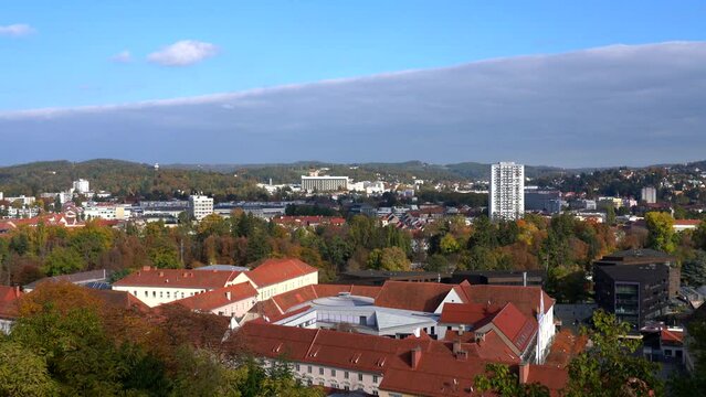 Aerial panorama view of Graz city old town from Schlossberg on a sunny day in autumn, with blue sky cloud and colorful trees, Graz, Styria, Austria