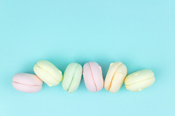 Beautiful variety of marshmallow looks like macaroons on pastel blue background.