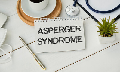 Doctor keeps a card with the name of the diagnosis -asperger syndrome. Selective focus.