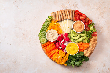 Colorful vegan Charcuterie board with raw vegetables and whole wheat snacks - obrazy, fototapety, plakaty