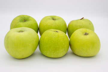 Few green apples on white background