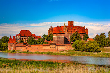 Naklejka na ściany i meble Poland. Malbork. The Castle of the Teutonic Order (UNESCO World Heritage Site) seen from the Nogat river