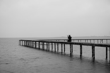 Shot of man taking pictures on the pier