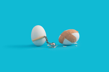 Funny Easter concept with white eggs fighting with medieval mace.
